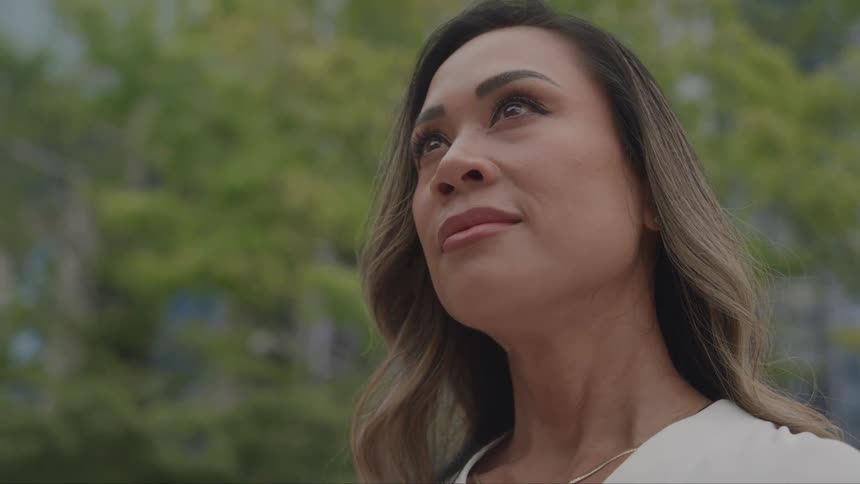 Woman outdoors in the city looking up