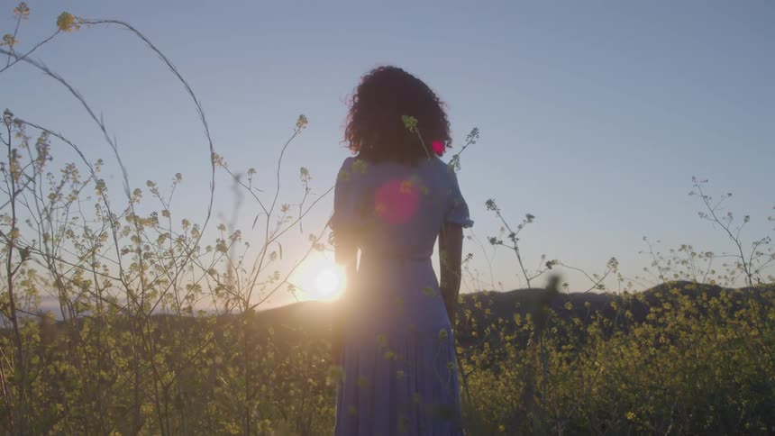 Woman in a field with yellow flowers