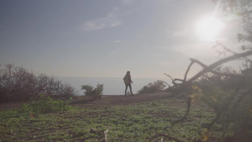 The person is hiking on the field