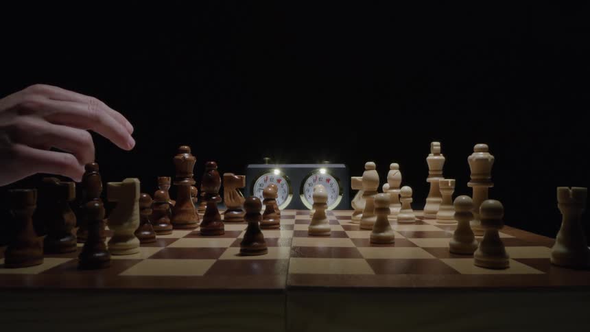Hands of two people playing a game of chess