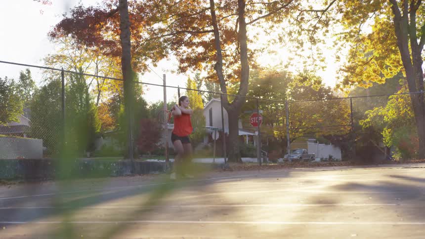 Woman playing tennis on an outdoor court