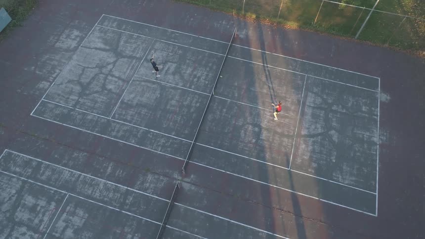 Aerial view of two people playing tennis on a court