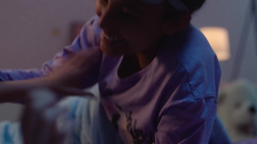 Two girls have a tickle fight during a sleepover