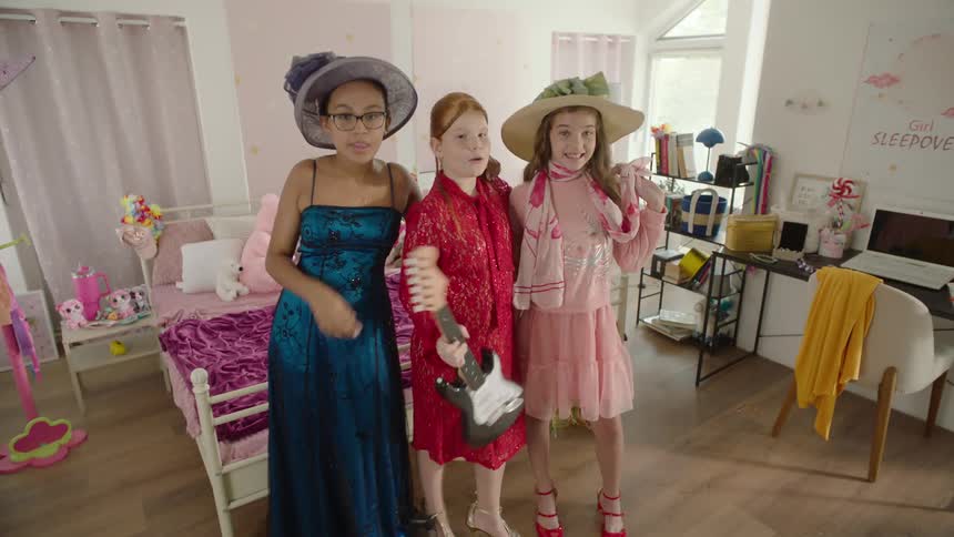 Girls are posing together in dresses