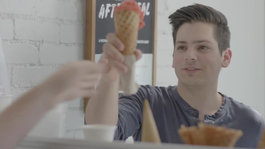 A man and woman order ice cream in an ice cream parlor