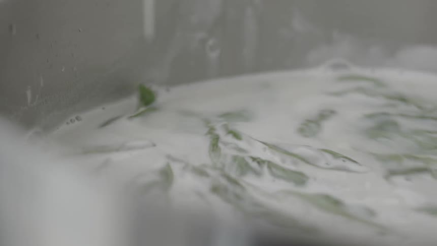Ingredients in a large pot are stirred with a spatula