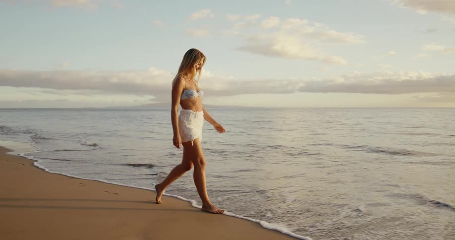 Blonde woman walking on the beach