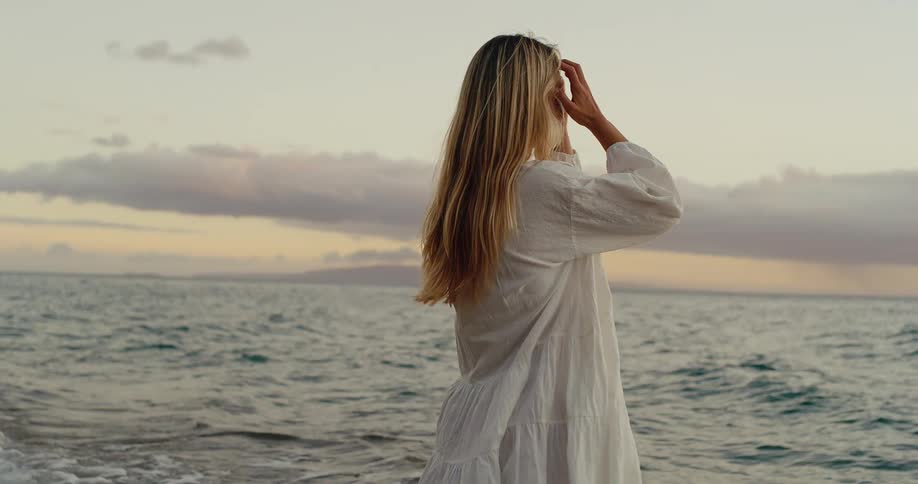 Woman in white dress at the beach sea