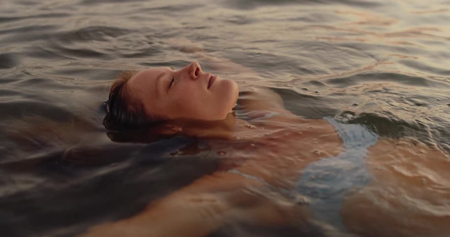 Woman floating in calm sea