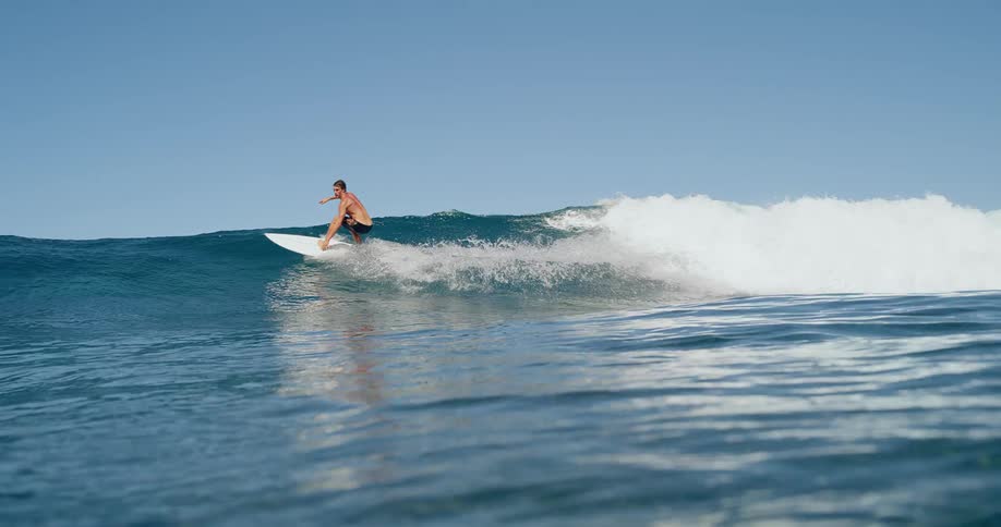 Man surfing a wave during the day