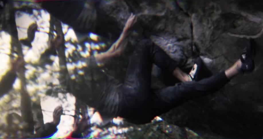 Three climbers scale a rock wall surrounded by motion blur and distortion