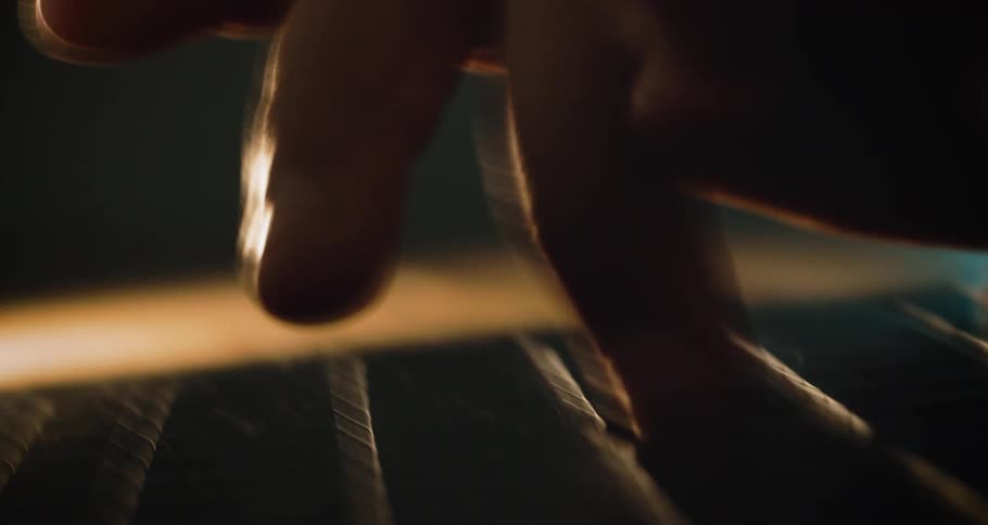 Close up of a male typing on a computer keyboard in a room