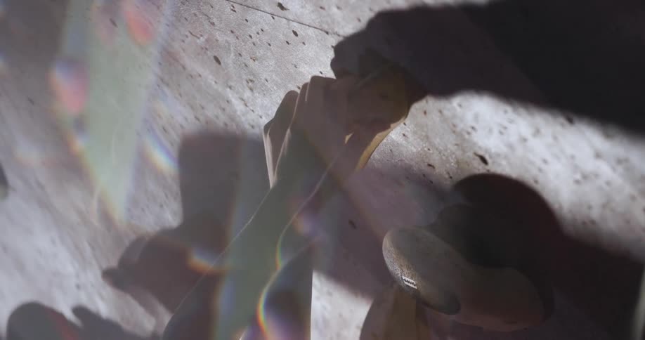 Hands gripping holds on an indoor climbing wall