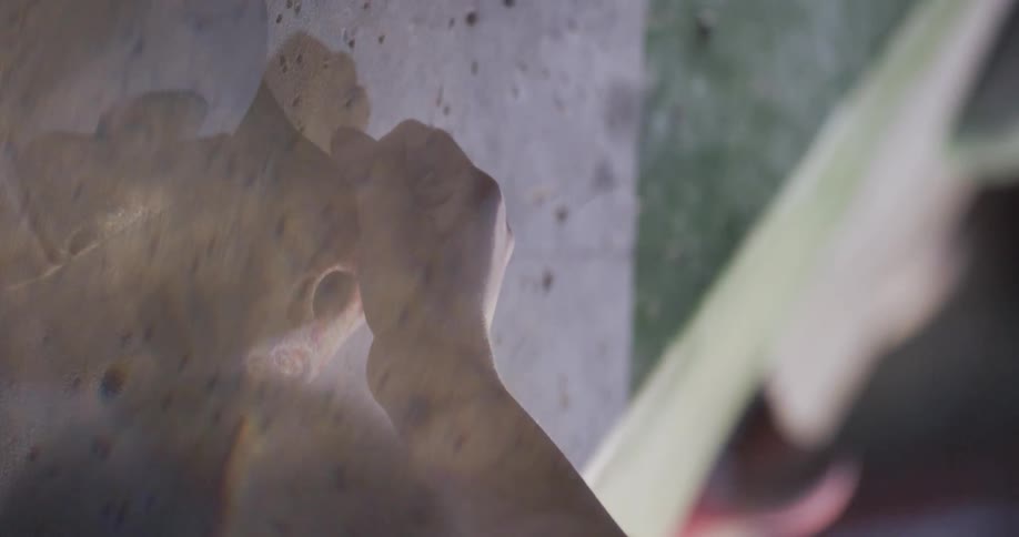 A woman is rock climbing on the wall