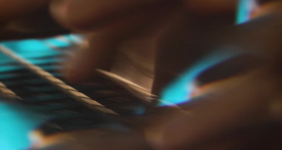 Pair of hands typing on a laptop keyboard