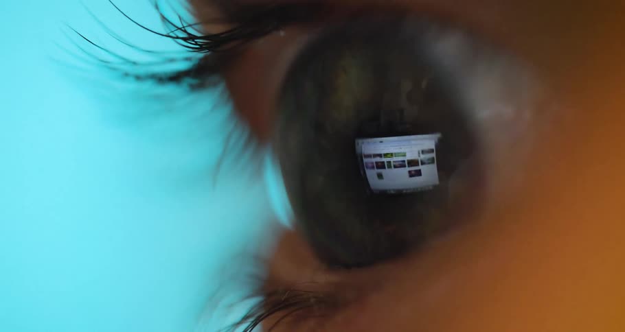 Extreme closeup of a persons eye displaying a computer screen