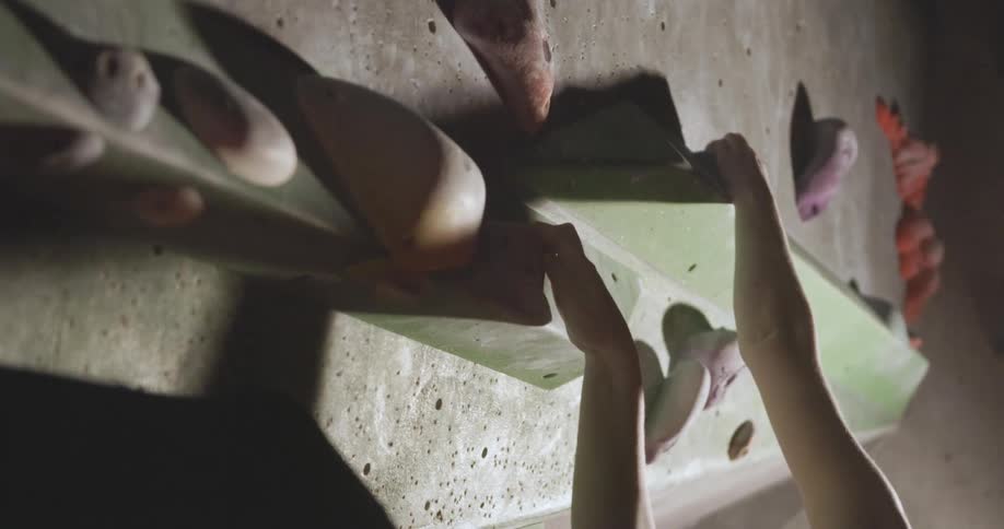 Woman training rock climbing on an indoor wall