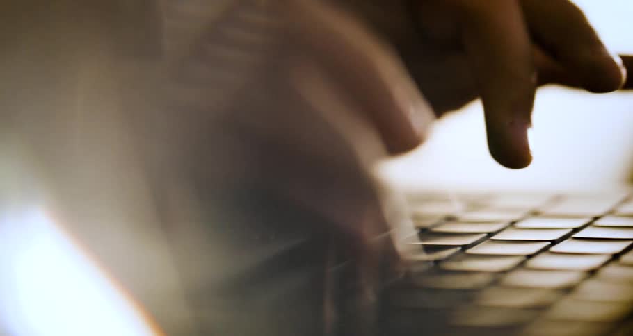 Pair of hands typing on a keyboard