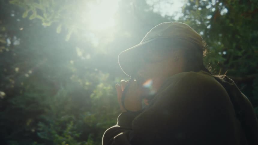 Woman taking pictures in a forest
