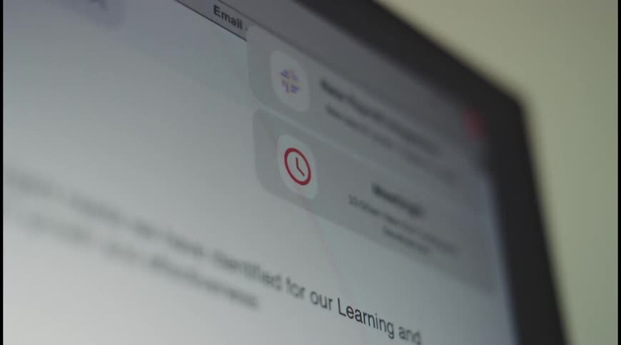 Computer screen shows a red clock icon in an email interface