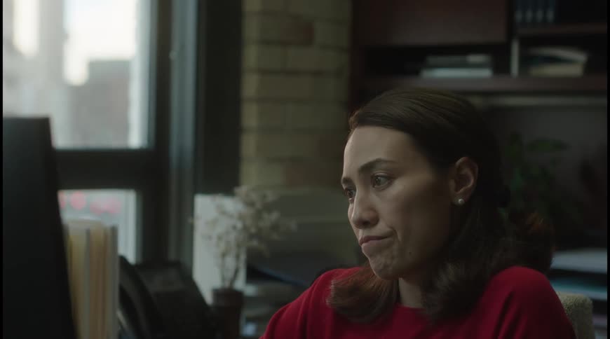 The woman is reading the computer screen in the office