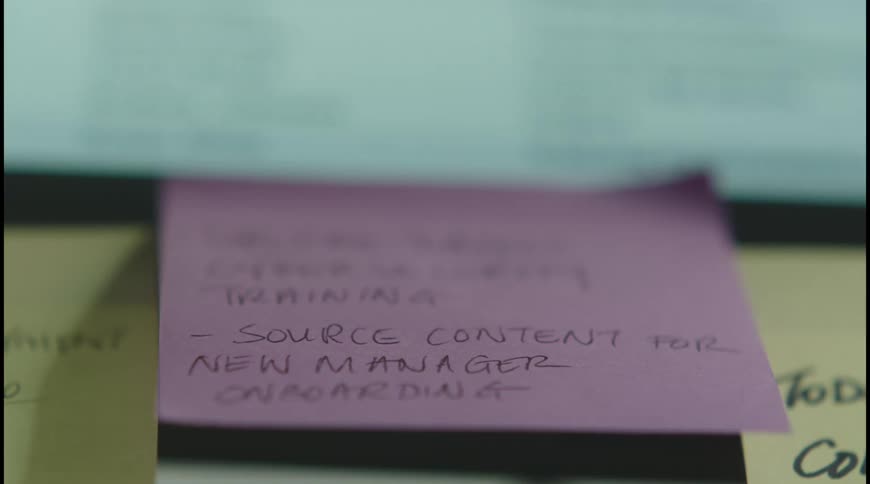 The post it attached to the monitor has a message