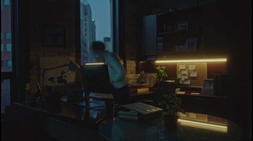 A woman working on an office setting at evening all in a time lapse scene