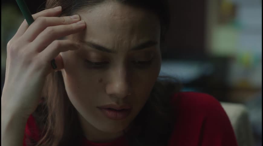 Woman with her hand on her head in thought