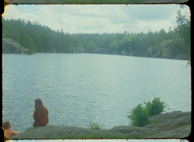 Two people are talking by the lake