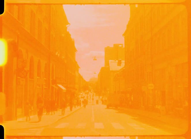 Pedestrians walk on an urban street during the day