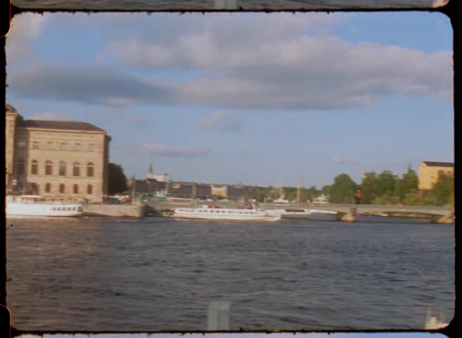The boats are in the river by the city