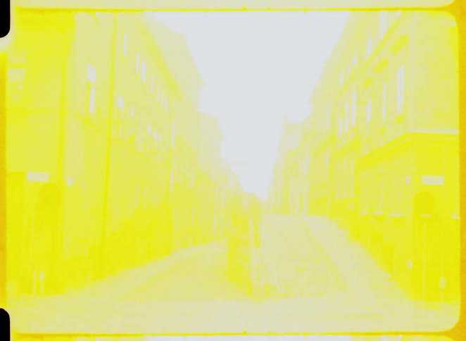 Cobblestone street flanked by old buildings in earthy tones