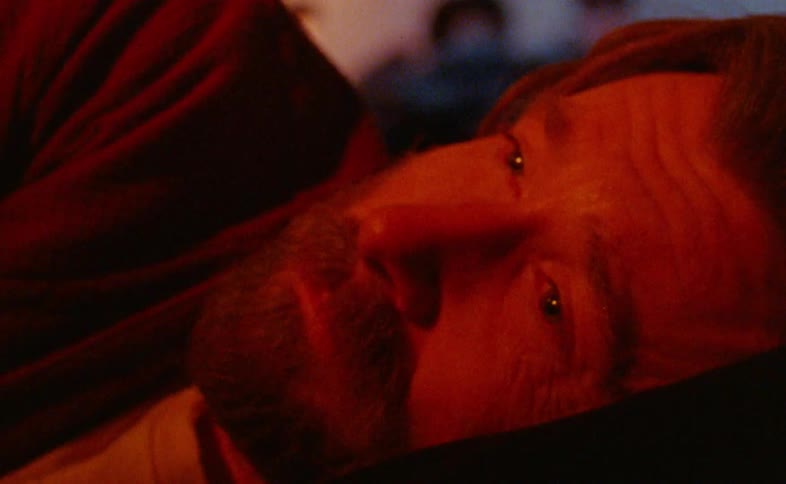 The man is resting in the dark room