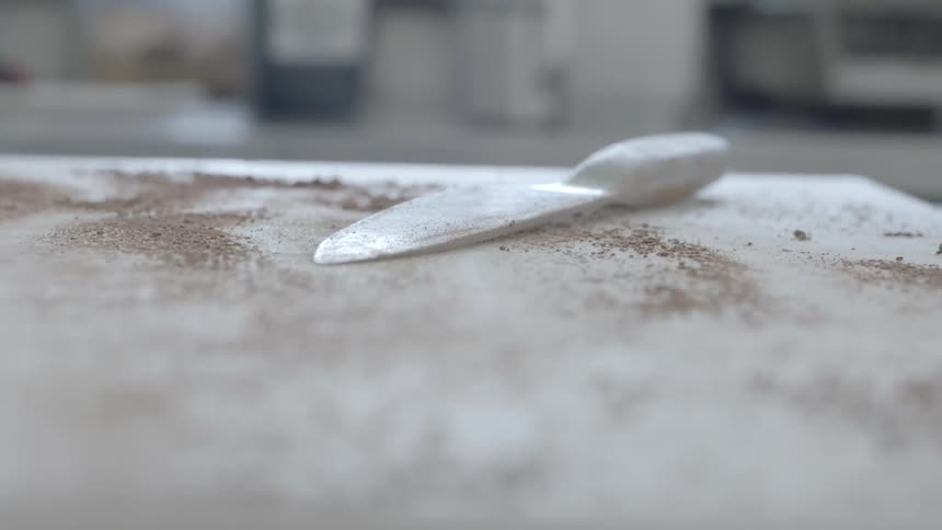 A kitchen table has a knife on it