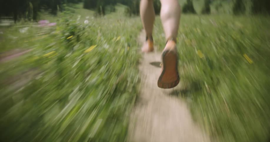 The woman is running on the small trail