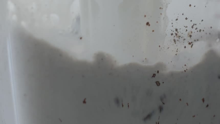 Milk is poured into a container of chocolate pieces