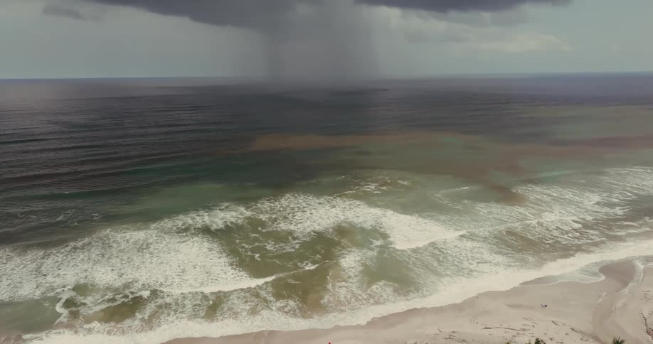 Waves hit the shore of the island