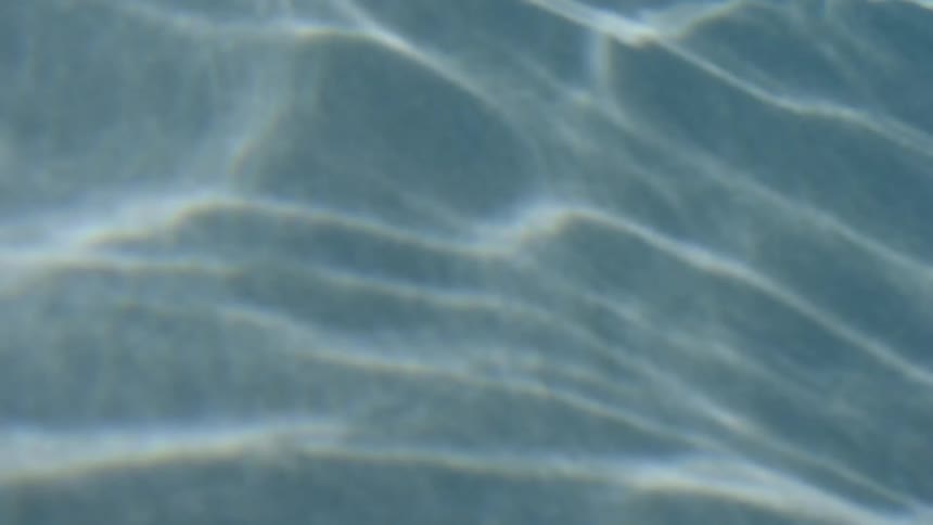The light is reflecting on the water of this pool