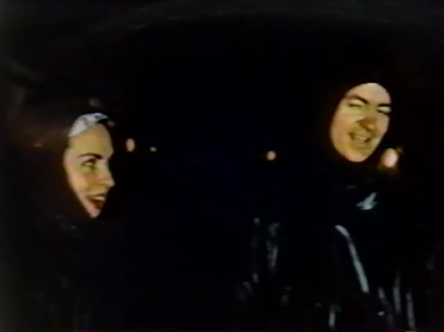A man and woman laugh and talk