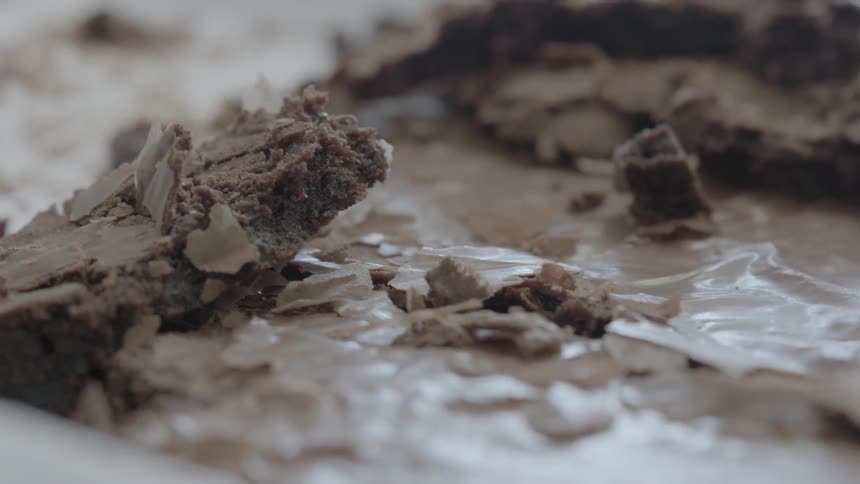 Close up of a brownie being taken out of a pan