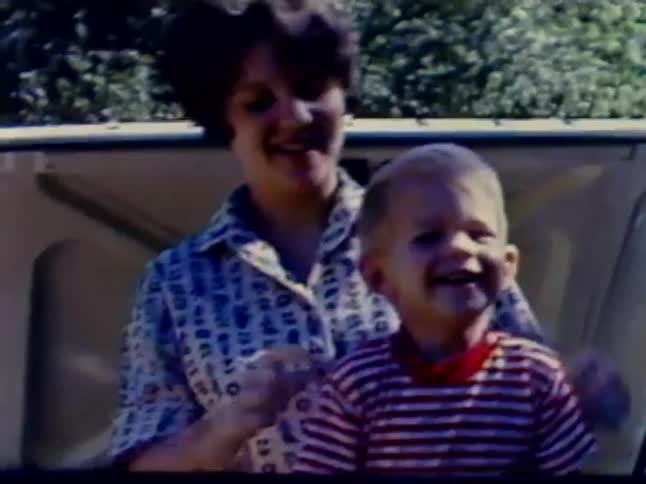 A woman and child smile and play