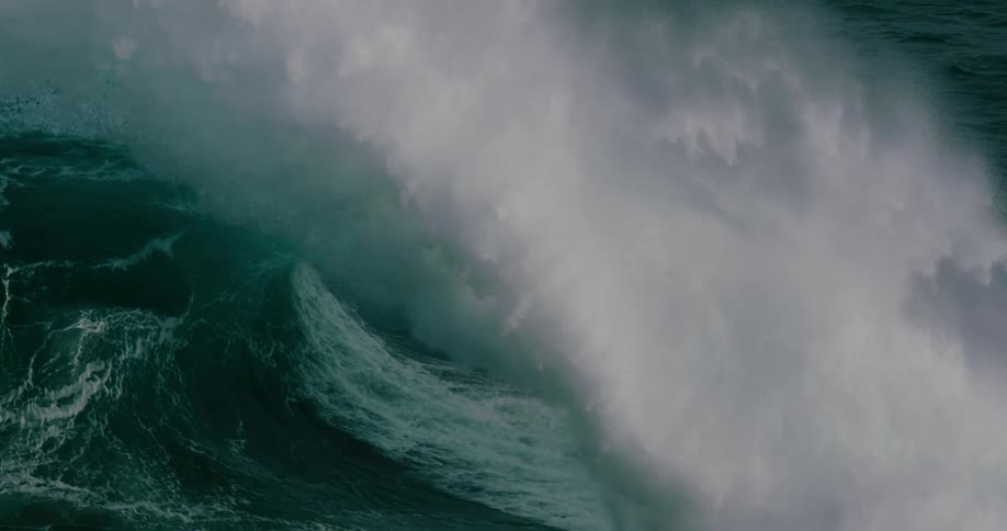 Giant wave curls forming a tube in the ocean