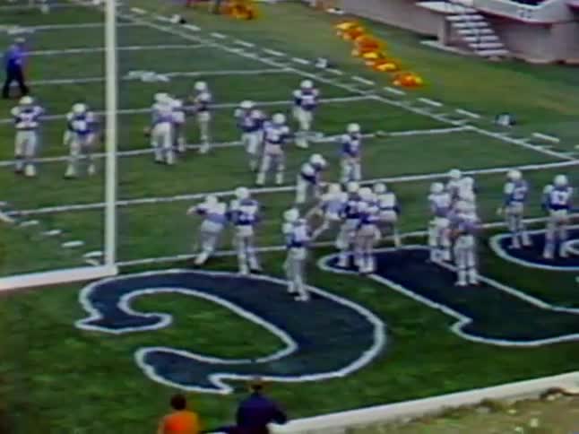 Football players set up for a play on the field