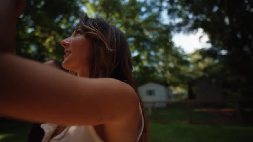 Smiling woman and man outdoors among trees
