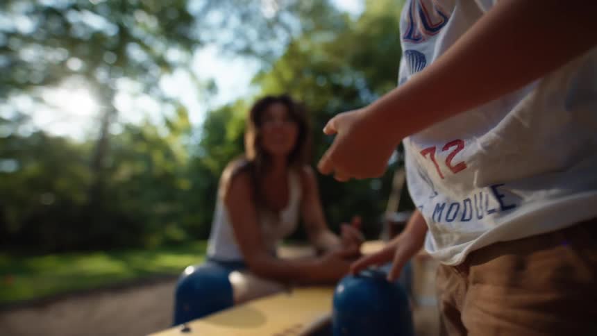 Mother watches her son at an outdoor playground