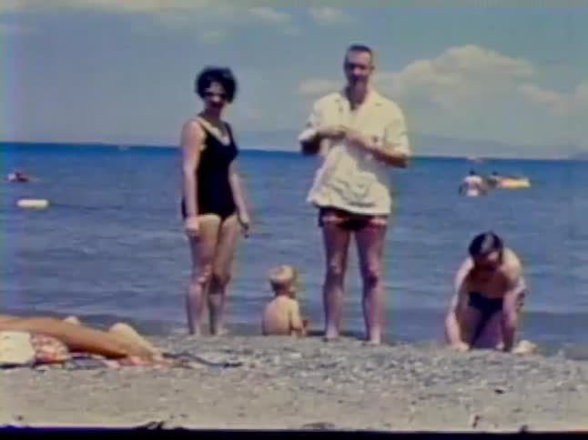 A family plays in the sand of a beach