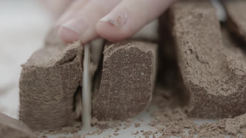 A person chops chocolate with a knife