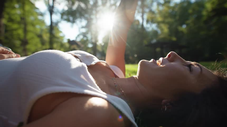 Happy woman lying on the grass