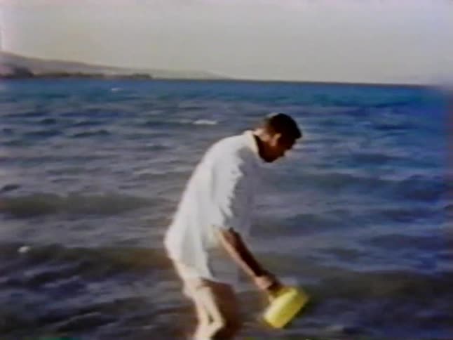 A man pales some water in the ocean