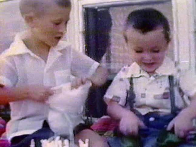 Two children open gifts together